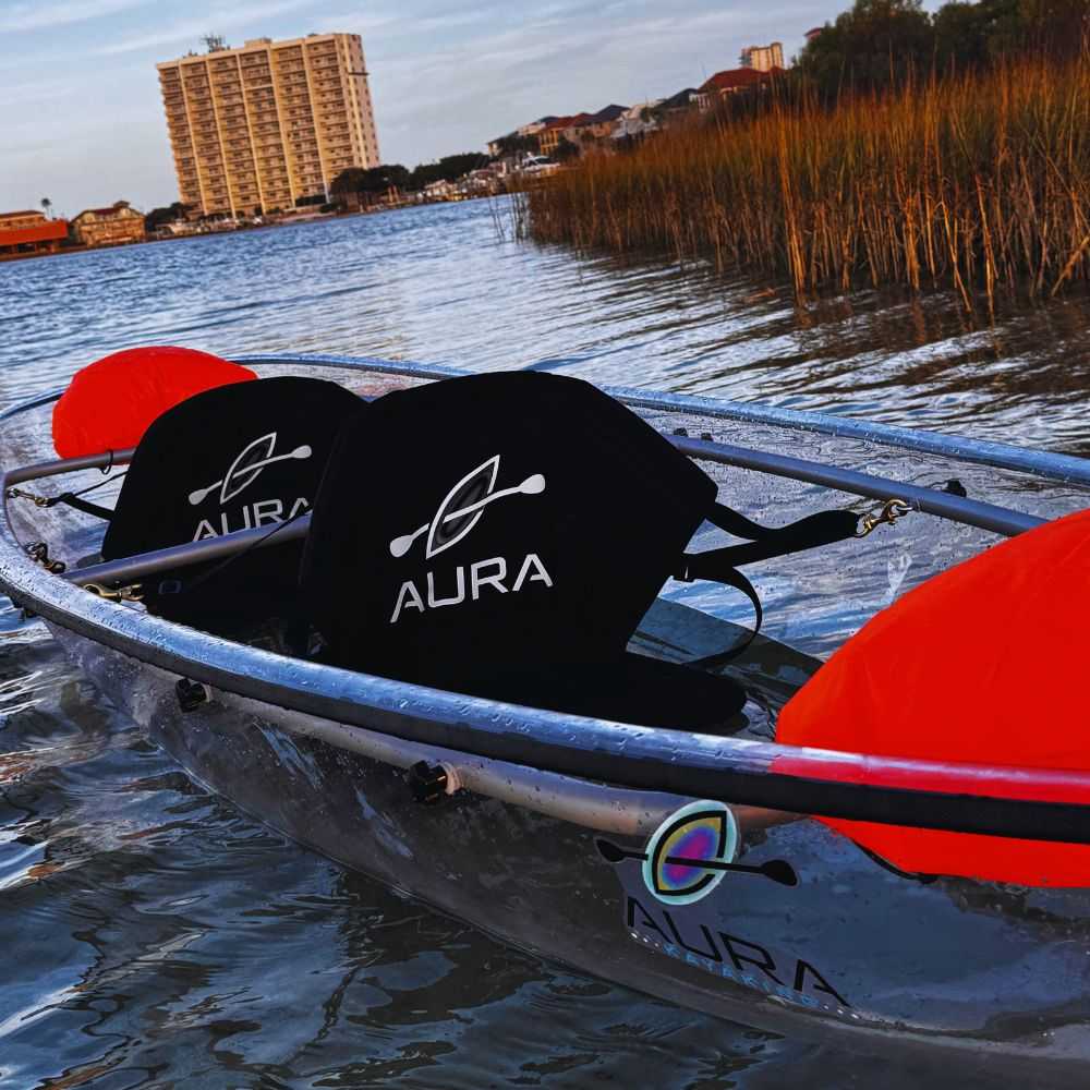 Aura transparent canoe on water with two seats.