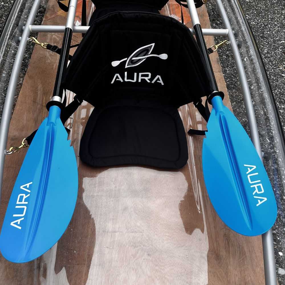 Aura Adventurer clear-bottom kayak close-up of seat and paddles.