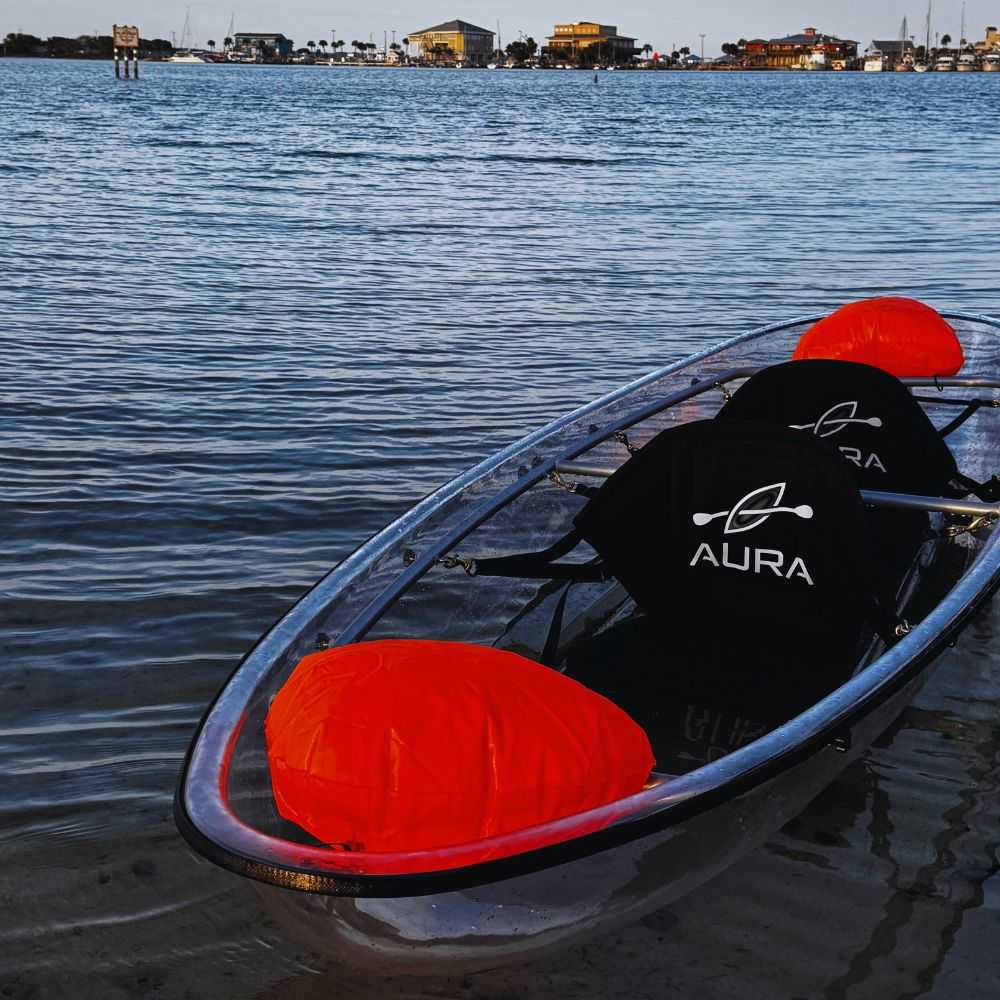 Aura Adventurer see through canoe on the water with two seats.