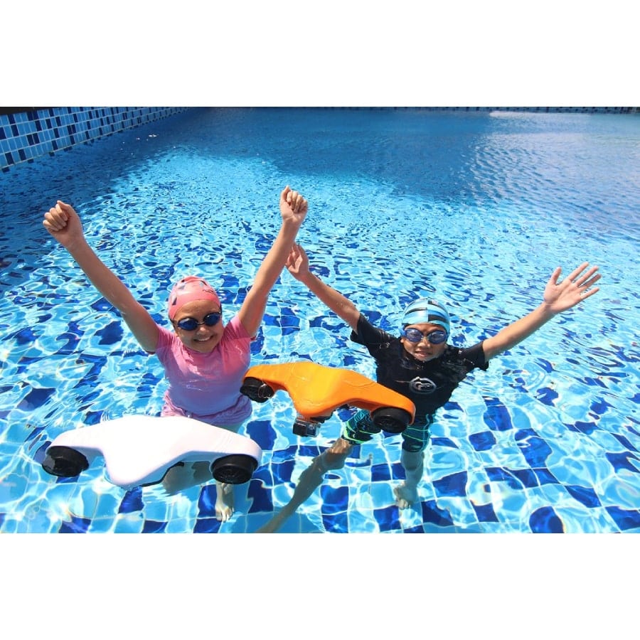 Two kids with floating Asiwo Manta underwater scooters in pool.