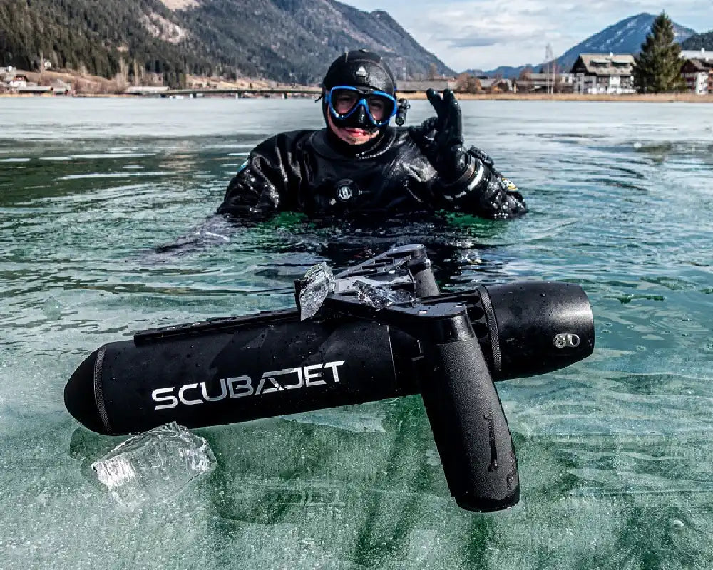 Scubajet Pro underwater scooter sitting on ice with diver in water.