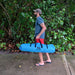Squatch and Siren Sea Sleigher parrotfish blue most portable inflatable dive accessory rolled up and being carried by an adult.