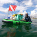Squatch and Siren Sea Sleigher moray green inflatable dive raft on the water with a cooler, dive flag, other gear, and adult on top.
