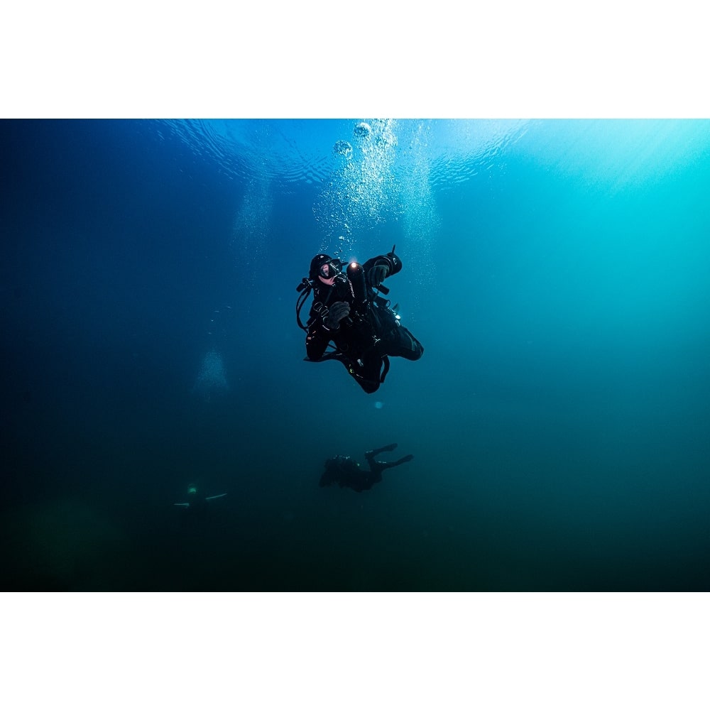 Scuba divers using BEAM LED on SCUBAJET PRO Dive Kit underwater scooter.