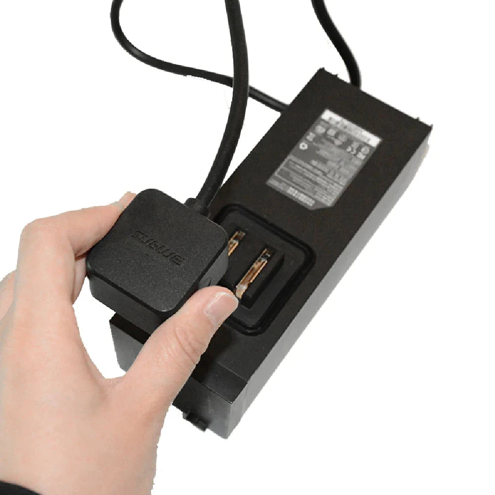 Adult putting Sublue WhiteShark Mix Rapid 2-hour Battery Charger on battery.